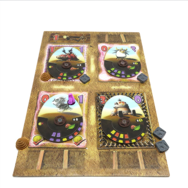 May include: A game board with four colorful spinning wheels, each with a different monster character. The board is made of cardboard and has a brown and tan color scheme. The numbers 1, 0, and 3 are visible on the wheels.