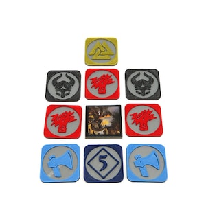 May include: A set of 10 square game tokens with various symbols and a number 5. The tokens are in shades of red, blue, gray, and gold.