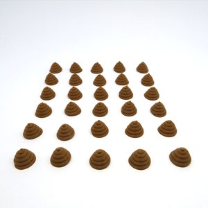 May include: A collection of 25 brown, cone-shaped, decorative items arranged in rows on a white surface.