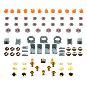 May include: A set of 3D printed miniature game pieces for tabletop role-playing games. The set includes a variety of objects, such as fire, hearts, stairs, bones, and chalices.