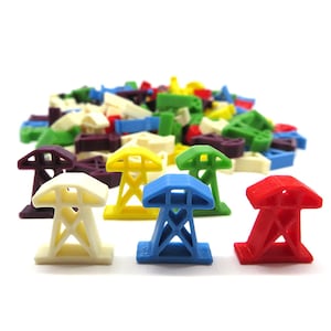 May include: Five plastic power line tower pieces in different colours: white, yellow, blue, red, and purple. The pieces are small and detailed, with a simple design.
