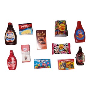 May include: A collection of miniature food items, including chocolate syrup, root beer concentrate, chocolate bars, crackers, candy, and ice pops. The items are all packaged in colorful boxes and bags.