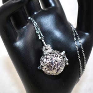 Silver Angel caller bola harmony chime ball necklace. Cut-out leaf pendant, chime ball Legend says this soft chiming sound calls your guardian angel Angel caller locket, 316 stainless steel chain. Popular with expectant Mothers. Jewelry gift for her. birthday gift, Christmas gift for her, harmony chime ball locket necklace, metallic pink harmony chime ball, gift for wife, gift for Mom, gift for daughter, gift for sister, silver angel caller necklace gift for her