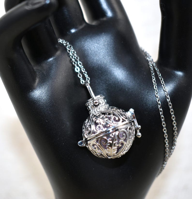 Silver Angel caller bola harmony chime ball necklace. Cut-out leaf pendant, chime ball Legend says this soft chiming sound calls your guardian angel Angel caller locket, 316 stainless steel chain. Popular with expectant Mothers. Jewelry gift for her. birthday gift, Christmas gift for her, harmony chime ball locket necklace, metallic pink harmony chime ball, gift for wife, gift for Mom, gift for daughter, gift for sister, silver angel caller necklace gift for her