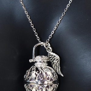 Silver Angel caller bola harmony chime ball necklace. Cut-out leaf pendant, chime ball Legend says this soft chiming sound calls your guardian angel Angel caller locket, 316 stainless steel chain. Popular with expectant Mothers. Jewelry gift for her. birthday gift, Christmas gift for her, harmony chime ball locket necklace, metallic pink harmony chime ball, gift for wife, gift for Mom, gift for daughter, gift for sister, silver angel caller necklace gift for her