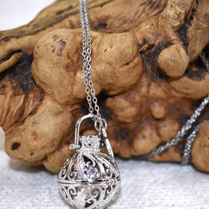 Silver Angel caller bola harmony chime ball necklace. Cut-out leaf sphere pendant, chime ball locket necklace, soft chiming sound calls your guardian angel, Angel caller locket, 316 stainless steel chain. Popular with expectant Mothers. Jewelry gift for her. Gift for Mom, gift for wife, gift for sister, gift for daughter, birthday gift, pregnancy jewelry