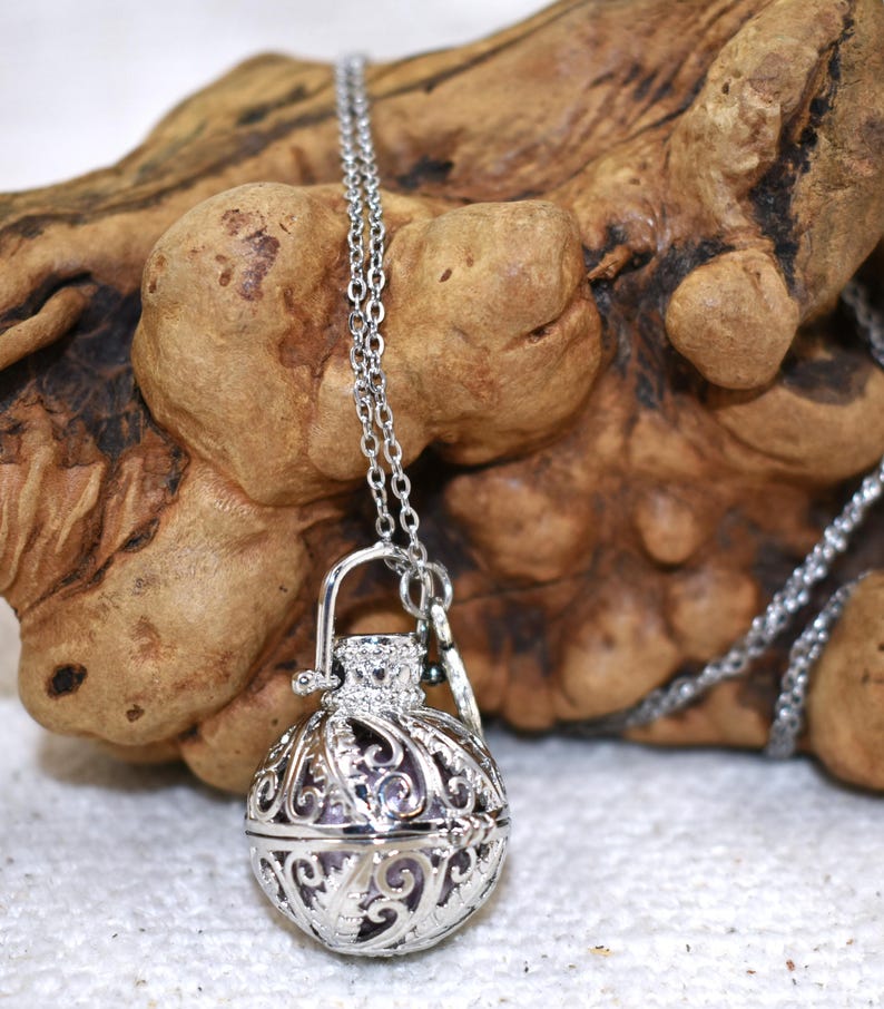Silver Angel caller bola harmony chime ball necklace. Cut-out leaf sphere pendant, chime ball locket necklace, soft chiming sound calls your guardian angel, Angel caller locket, 316 stainless steel chain. Popular with expectant Mothers. Jewelry gift for her. Gift for Mom, gift for wife, gift for sister, gift for daughter, birthday gift, pregnancy jewelry