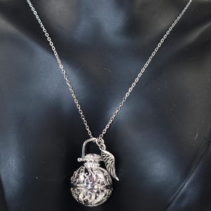Silver Angel caller bola harmony chime ball necklace. Cut-out leaf sphere pendant, chime ball locket necklace, soft chiming sound calls your guardian angel, Angel caller locket, 316 stainless steel chain. Popular with expectant Mothers. Jewelry gift for her. Gift for Mom, gift for wife, gift for sister, gift for daughter, birthday gift, pregnancy jewelry