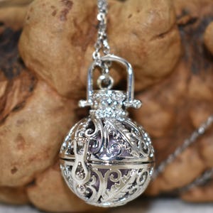 Silver Angel caller bola harmony chime ball necklace. Cut-out leaf sphere pendant, chime ball locket necklace, soft chiming sound calls your guardian angel, Angel caller locket, 316 stainless steel chain. Popular with expectant Mothers. Jewelry gift for her. Gift for Mom, gift for wife, gift for sister, gift for daughter, birthday gift, pregnancy jewelry