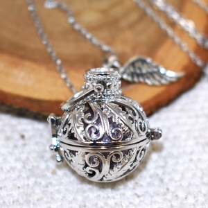 Silver Angel caller bola harmony chime ball necklace. Cut-out leaf sphere pendant, chime ball locket necklace, soft chiming sound calls your guardian angel, Angel caller locket, 316 stainless steel chain. Popular with expectant Mothers. Jewelry gift for her. Gift for Mom, gift for wife, gift for sister, gift for daughter, birthday gift, pregnancy jewelry