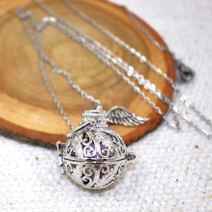 Silver Angel caller bola harmony chime ball necklace. Cut-out leaf sphere pendant, chime ball locket necklace, soft chiming sound calls your guardian angel, Angel caller locket, 316 stainless steel chain. Popular with expectant Mothers. Jewelry gift for her. Gift for Mom, gift for wife, gift for sister, gift for daughter, birthday gift, pregnancy jewelry