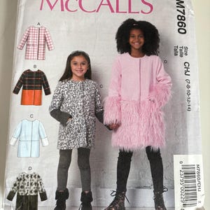 May include: McCall's sewing pattern M7860 for girls' coats. The pattern cover features illustrations of different coat styles, including a pink coat with faux fur trim and a black and orange plaid coat. Two girls model the coats.