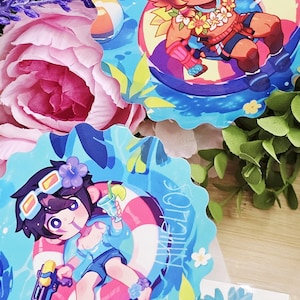 May include: Two circular stickers with cartoon characters in a summer theme. One features a red-haired character in sunglasses on a floatie. The other shows a character with a water gun and a drink. The stickers are surrounded by blue and white wave patterns.