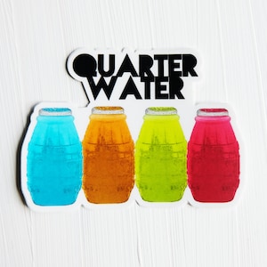 May include: A sticker with the text "QUARTER WATER" in black letters on a white background. Four plastic bottles of different colors are arranged in a row below the text. The bottles are blue, orange, green, and red.