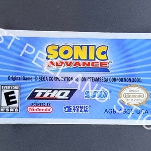 May include: A blue and yellow game cartridge for the Game Boy Advance. The cartridge is labeled "Sonic Advance" with the text "Original Game. © SEGA CORPORATION © SONICTEAMSEGA CORPORATION 2001." The cartridge has an ESRB rating of "Everyone" and is licensed by Nintendo.