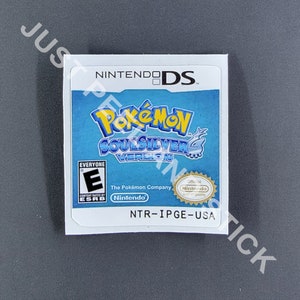 May include: A Nintendo DS game cartridge for Pokémon SoulSilver Version. The label features the game's logo in blue and yellow, with the ESRB rating and Nintendo branding. The cartridge is white with the text "NINTENDO DS" at the top.