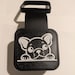 A black and white rubber 2 inch tail hitch cover with a 3d printed picture of a french bull dog