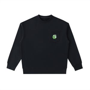 May include: Black long-sleeve sweatshirt with a crew neck and a pocket on the chest. The pocket features a green cartoon frog wearing glasses. The sweatshirt is made of a soft material.