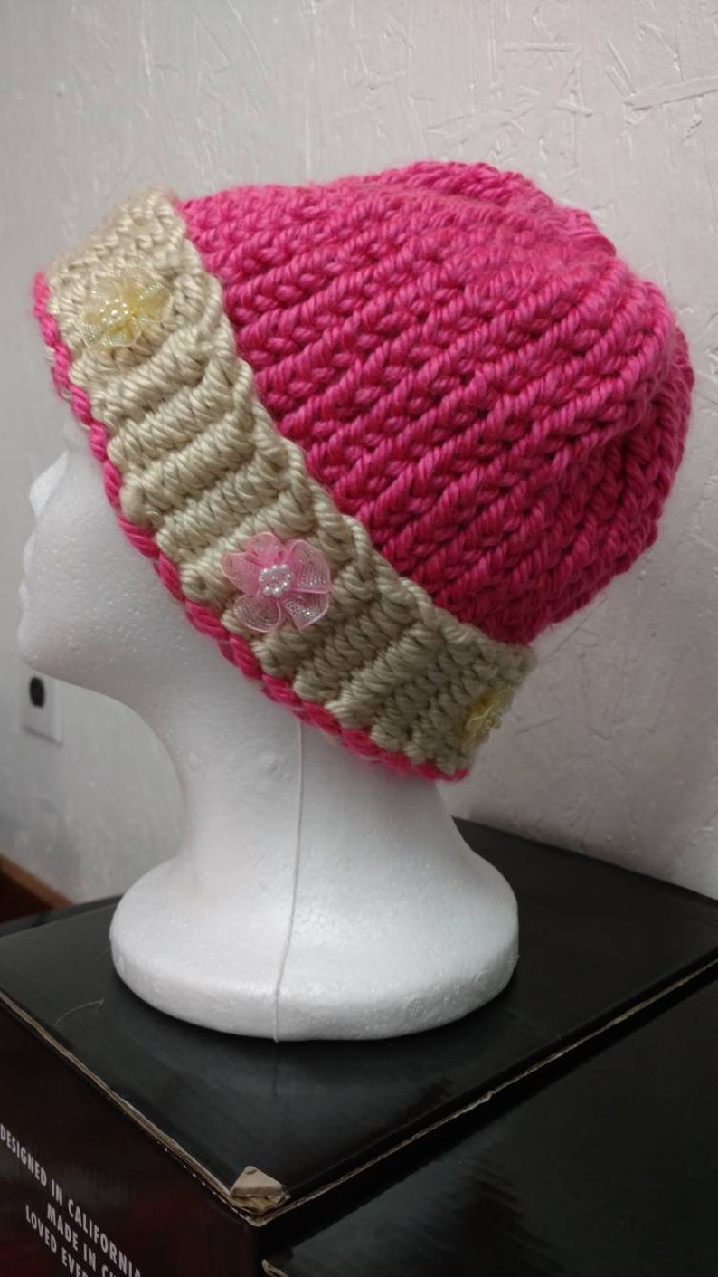 Tan brim with pink body. Stylish Winter Cap for young adult or adult has lovely colorful fleurs with small rhinestone sequin in center
