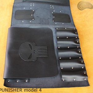 May include: Black leather tool roll with the Punisher skull logo embossed on the front. The roll features multiple pockets, a zippered compartment, and is secured with metal rivets. The text "PUNISHER model 4" is visible at the bottom.