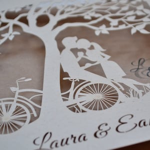 laser cut invitation with bike and couple under the tree.