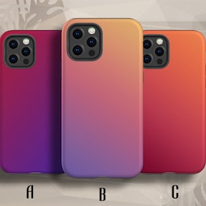 May include: Three phone cases with a gradient design. The case on the left is purple to pink, the middle case is light purple to orange, and the case on the right is red to orange.
