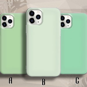 May include: Three phone cases in different shades of green. The cases are clear and show the phone's camera lens. The cases are labeled A, B, and C.
