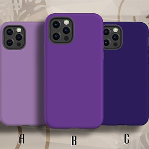 May include: Three phone cases in different shades of purple. The cases are made of a soft, flexible material and have a smooth finish. The cases are designed to fit a smartphone with a triple camera system.