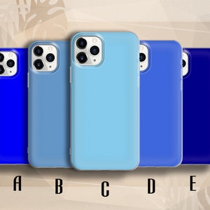 May include: Five phone cases in varying shades of blue. Each case features the same design, with a raised camera bump and a smooth, matte finish. The cases are lined up from left to right, starting with the darkest blue on the left and ending with the lightest blue on the right.