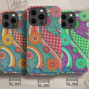 May include: Three phone cases with colorful floral designs. The cases feature a retro style with flowers, swirls, and checkerboard patterns in shades of teal, pink, orange, and purple. Each case has a camera cutout and a card slot at the bottom.