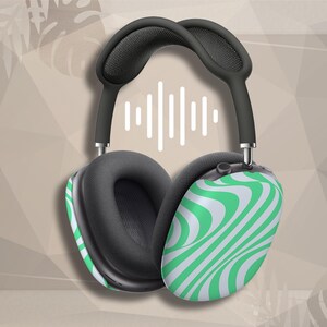 May include: Over-ear headphones featuring a black headband and black ear cushions. The outer ear cups display a vibrant green and white wavy, swirling pattern. A white graphic icon representing a sound wave is positioned between the headband.