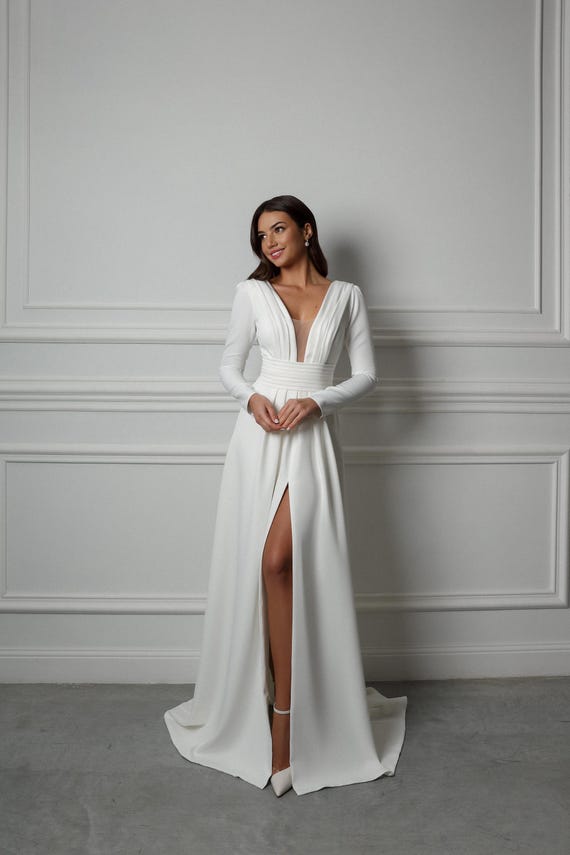 satin vs crepe wedding dress Minimalist Crepe Wedding Dress: Deep V-neck, Long Sleeves, Front Slit
