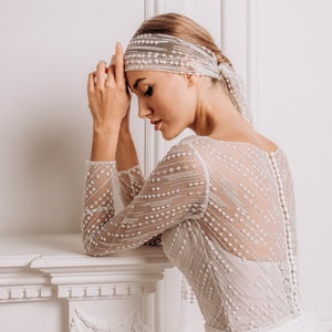 The delicate lace top add a touch of romance, while the smooth crepe bottom create a sleek silhouette.