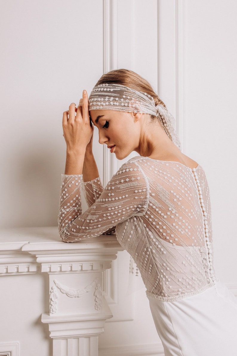 The delicate lace top add a touch of romance, while the smooth crepe bottom create a sleek silhouette.