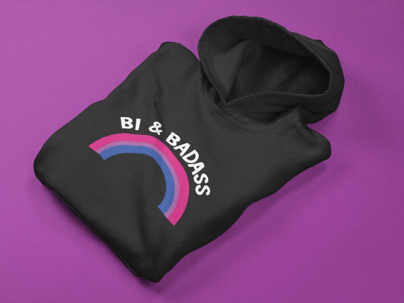 May include: Black hoodie with a rainbow graphic and the text "Bi & Badass" in white.