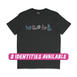 May include: A dark grey t-shirt with a line of colourful cats printed on the front. The text "8 IDENTITIES AVAILABLE" is printed on a pink banner below the cats.