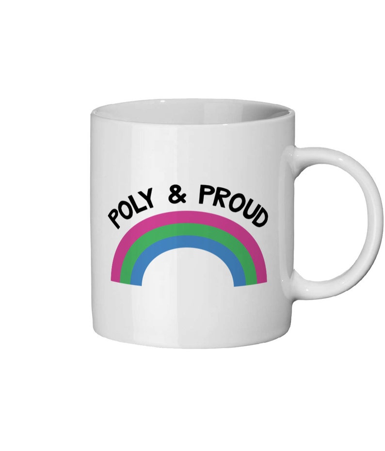 May include: White ceramic mug with a rainbow design and the text "POLY & PROUD" in black.