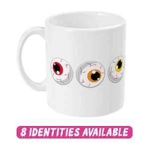 May include: White ceramic mug featuring a design of four cartoon eyeballs. The eyeballs have red, orange, and yellow irises. The mug has a black handle.