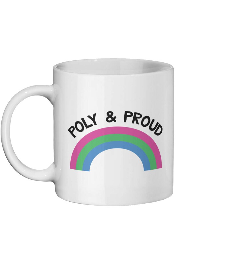 May include: White ceramic mug with a rainbow design and the text "POLY & PROUD" in black.