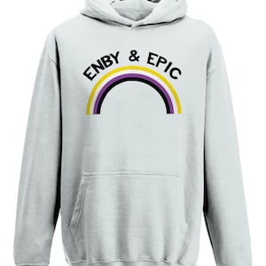 May include: Light blue hoodie with a black print that says "Enby & Epic" with a rainbow arc in yellow, purple, and black.
