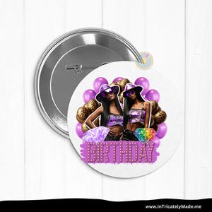 May include: A round button with a silver backing featuring a graphic of two women wearing purple outfits and sunglasses, surrounded by purple and leopard print balloons. The word "BIRTHDAY" is displayed in purple with a light-up effect.