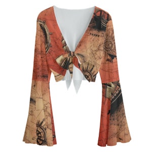 May include: A red and brown cropped top with long bell sleeves. The top features a tie front and a vintage map print with nautical compass and ship illustrations.