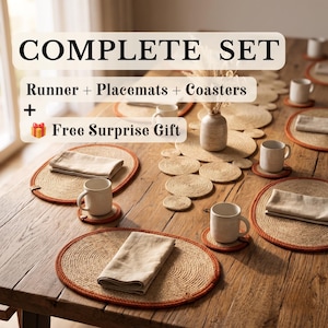 May include: A complete set of natural fibre table runners, oval placemats, and round coasters with orange trim. The set includes beige linen napkins and white ceramic mugs. Text reads: COMPLETE SET, Runner + Placemats + Coasters + Free Surprise Gift.