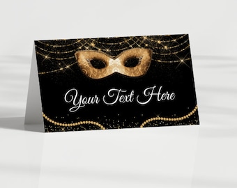 May include: Black and gold place card with a gold masquerade mask and the text "Your Text Here".