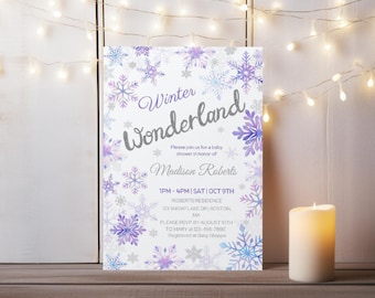 Op de afbeelding: Een rechthoekige uitnodigingskaart met een witte achtergrond en een rand van aquarel sneeuwvlokken in paarse, blauwe en zilveren tinten. De tekst luidt Winter Wonderland, Please join us for a baby shower in honor of Madison Roberts.
