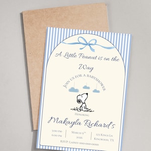 May include: Baby shower invitation with a blue and white striped border. The invitation features the text "A Little Peanut is on the Way" and a Snoopy graphic. The invitation is for Makayla Richard's baby shower.