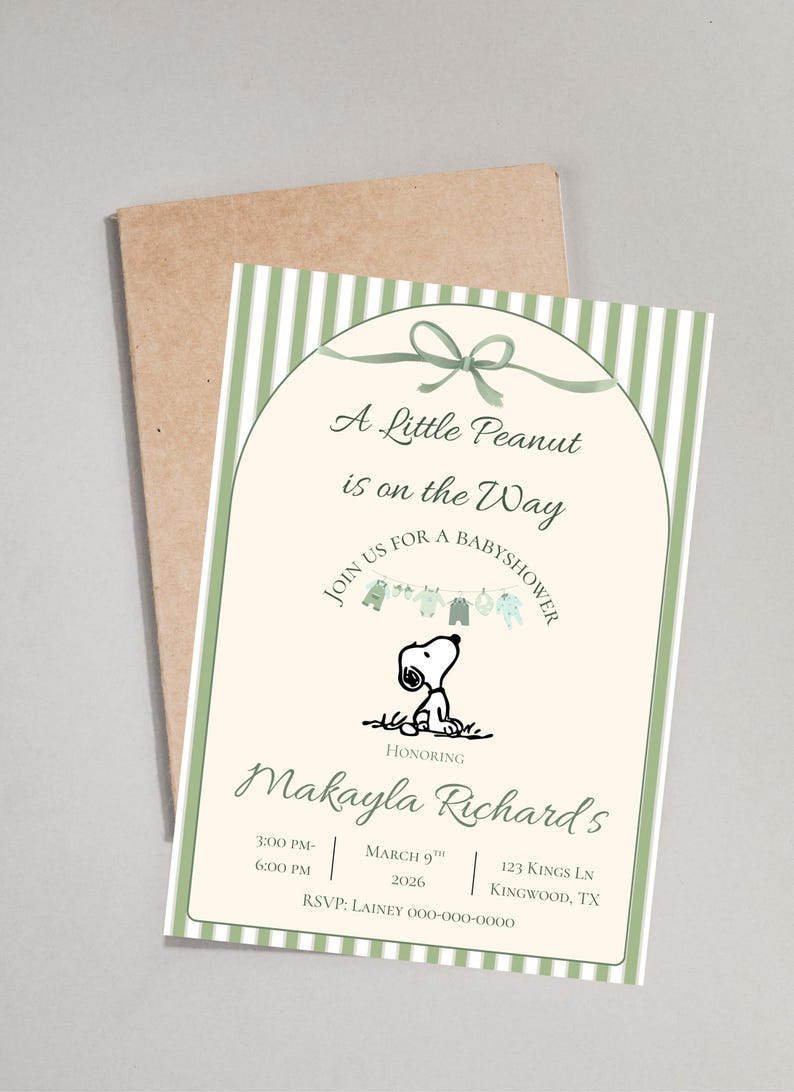 May include: Baby shower invitation featuring Snoopy, with text "A Little Peanut is on the Way." The invitation has a green and white striped border and includes event details. A brown envelope is behind the invitation.