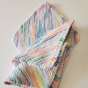 May include: A soft, multi-colored knitted baby blanket with stripes of pink, blue, yellow, and green.