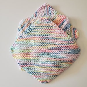 May include: Two pastel-colored knitted dishcloths with a striped pattern in shades of pink, blue, yellow, and white.