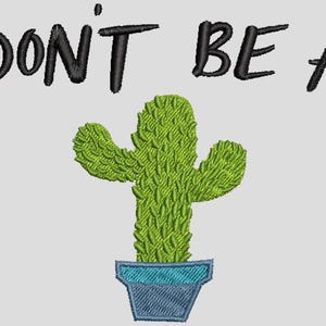 May include: Embroidered design featuring a green cactus in a blue pot, with the words "DON'T BE A" above. The cactus has a textured appearance, and the text is in a bold, black font. The design is on a light gray background.